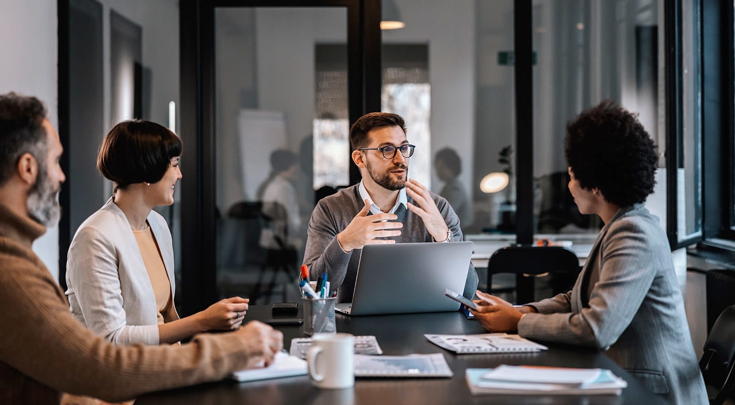A team of professionals gather in a conference room for discussion to increase functionality to the company’s operations.